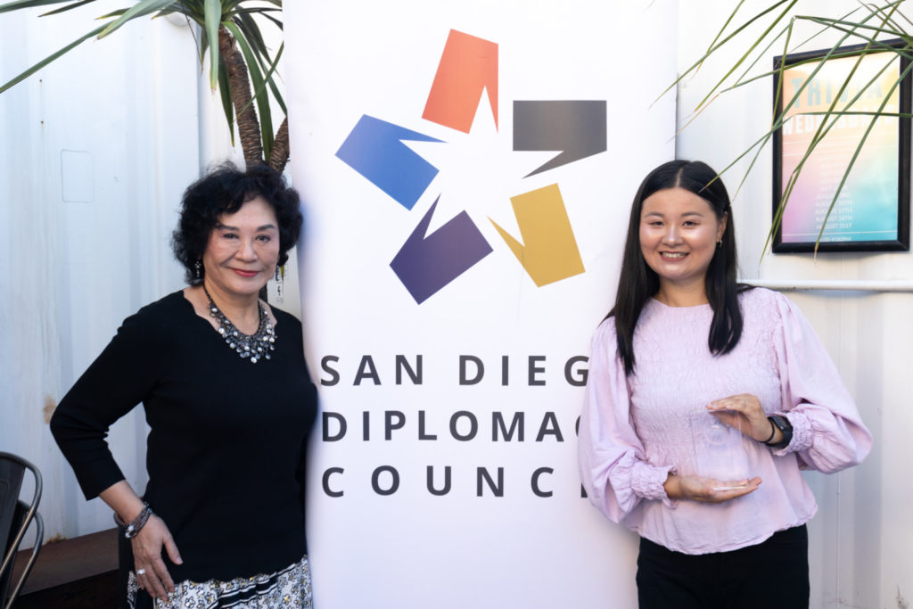 A banner of the San Diego Diplomacy Council with Chinyeh Hostler on the left, and representative of the Wendy Gillespie Center for Advancing Global Business on the right.