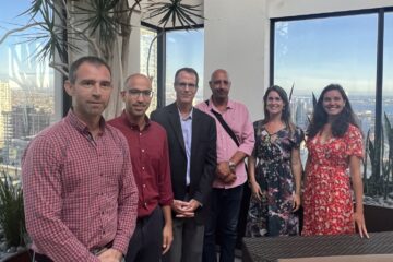 Migration Issues delegation with Ric Bainter (center). Background view of San Diego Downtown and Pacific Ocean
