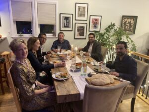 A group of SDDC members host international visitors for dinner.