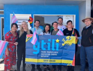 A group of program participants stand with a "ytili" pride banner.